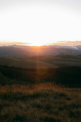 Reddish, golden and orange sunset between mountains