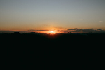 Reddish, golden and orange sunset between mountains