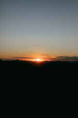 Reddish, golden and orange sunset between mountains