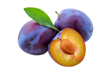 Ripe purple plums one cut in half showing seed and flesh fruit fresh