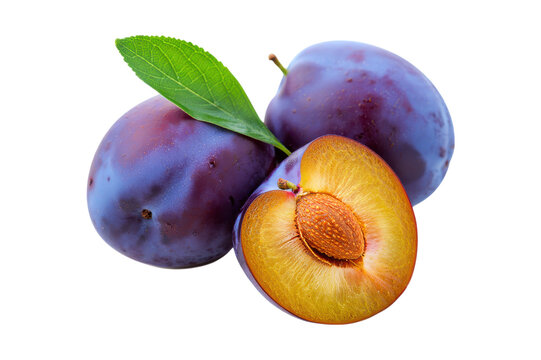 Ripe purple plums one cut in half showing seed and flesh fruit fresh