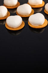 Lavender mousse cakes isolated on black background. Tasty sweet dessert. Ideal for gourmet dessert lovers. Vanilla sable, lemon curd, blueberry custard, lime mousse