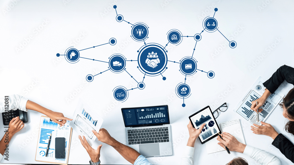 Aufkleber Engaging view of a digital network showcasing business collaboration. Modern devices, analytics charts, and team interaction highlight a progressive work environment focused on teamwork. Amity