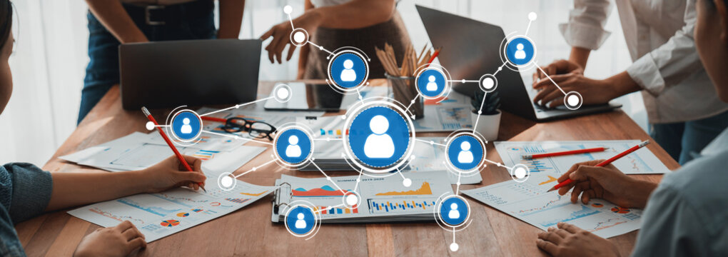 Analyst team utilizing BI Fintech to analyze and pointing at financial dashboard paper office. Businesspeople examining report paper on table for business insight. Panorama shot. Scrutinize Amity