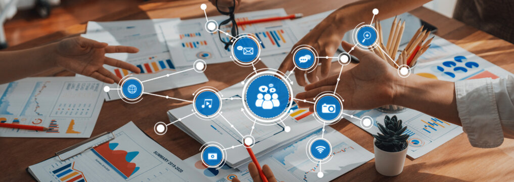 Analyst team utilizing BI Fintech to analyze and pointing at financial dashboard paper office. Businesspeople examining report paper on table for business insight. Panorama shot. Scrutinize Amity