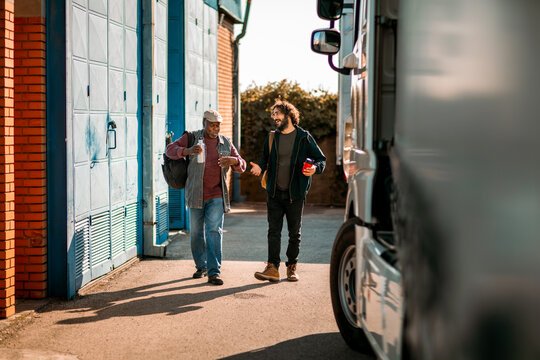 Truck drivers talking during break outside warehouse