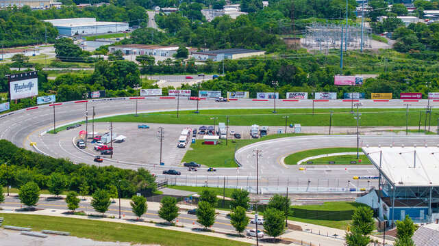 Aerial shot of the Fairgrounds Speedway Nashville with cars on the track and miles of lush green trees in Nashville Tennessee USA