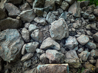 a heap of loose rocks with dirt of various sizes to use for erosion control and shoreline stability construction projects. abstract texture background