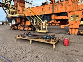 construction site with crane and concrete blocks, wire slings, in port