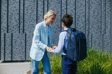 Mother and Schoolboy Talking Outside in Front of the School Building