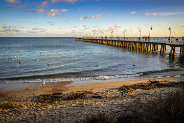 Sunset sky and beautiful old pier on the Baltic Sea in Gdynia, Poland
