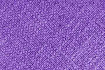 Close up, macro of purple woven fabric with detailed texture and diagonal pattern. Textile, cloth, material, fashion, upholstery, or abstract design background.