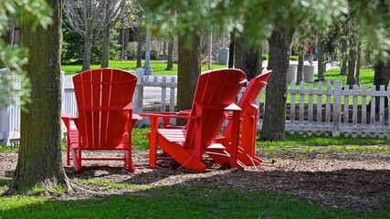 Landscape of the public park with red Adirondack chair