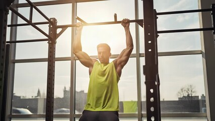 Athletic man doing pull-ups on bar in gym, fitness workout, training - Powered by Adobe