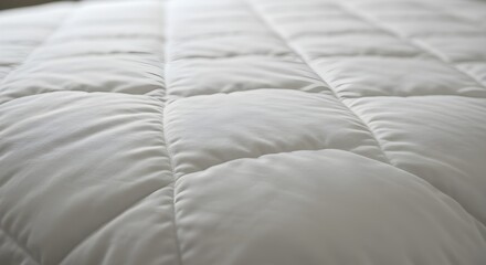 Obraz premium A closeup of a bed with a white comforter isolated on white background.