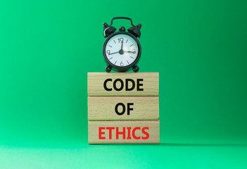 Code of ethics symbol. Concept words Code of ethics on wooden blocks with alarm clock. Beautiful...