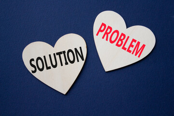 Solution vs Problem symbol. Concept word Solution vs Problem on wooden hearts. Beautiful deep blue...