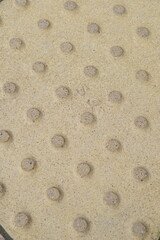 dirty yellow surface with round protrusions