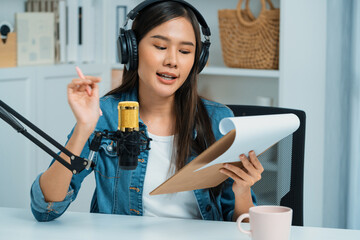 Host channel Asian influencer talking in broadcast streaming online wearing headset on social media...