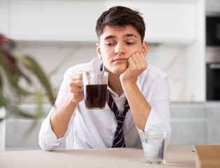 Capsule of effective medicine will help young man to relieve headache during hangover