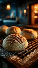Freshly baked bread rolls cooling on a grill in a rustic bakery at night