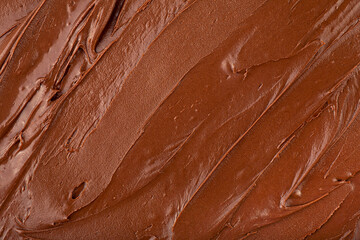 Melted chocolate cream as background, top view. Hazelnut cream, chocolate smear.