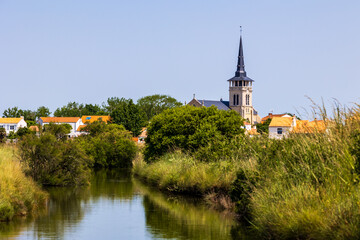 Fototapeta premium Saint-Martin-de-Vertou Church in the village of L’Île-d’Olonne seen from the salt marshes