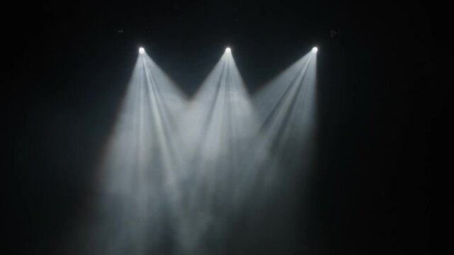  Dramatic Stage Spotlights on Dark Background - Three powerful spotlights piercing through darkness, creating a dramatic and professional stage lighting effect. Perfect for event promotion, product sh