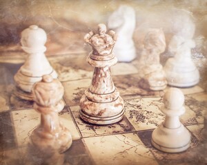 Chess queen on a vintage board