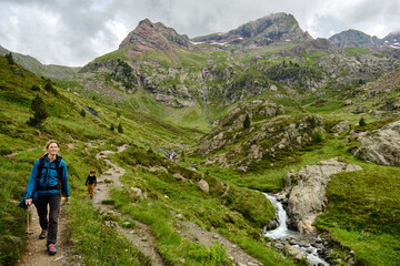 Fototapeta premium Mother and son walking along a trail in the mountains.