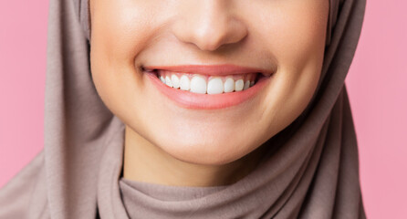 Dental care and stomatology concept. Closeup of wide white smile of muslim girl in hijab, young...