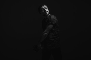 Professional male photographer with camera looking intently upwards. Striking black and white...