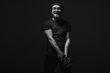 Professional male photographer with camera looking intently upwards. Striking black and white...