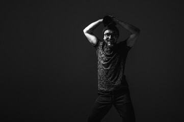 Professional male photographer with camera looking intently upwards. Striking black and white...