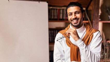 E-Learning And E-Teaching. Young Arab Male Teacher Standing Near Blackboard Teaching English...