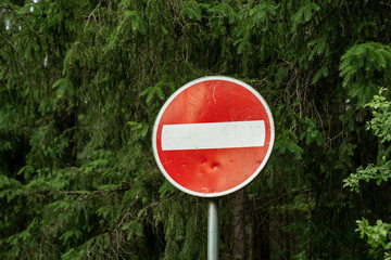 no entry traffic sign in forest area, red circular road sign with white bar, do not enter symbol,...