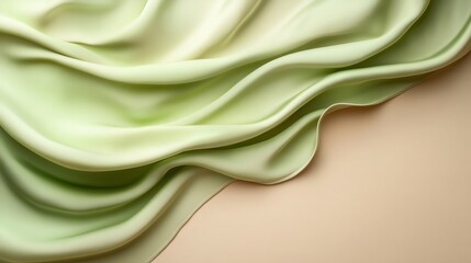Obraz premium A luxurious piece of green silk fabric elegantly drapes over a neutral background, emphasizing the beauty of fabric texture and color, creating a serene and calming atmosphere.