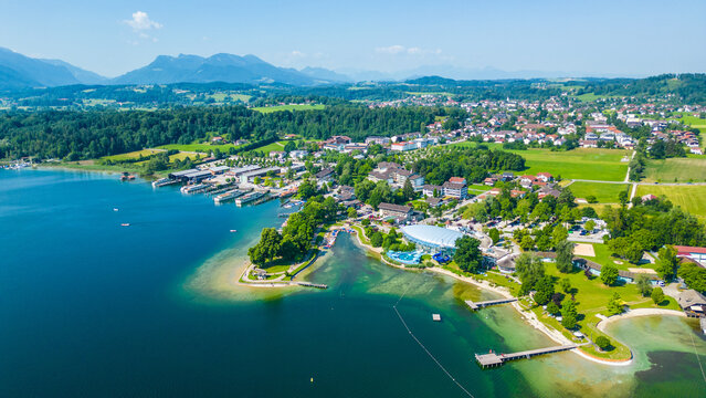 Aerial view of Prien am Chiemsee, a charming Bavarian town on the shore of Lake Chiemsee. Captured in summer, perfect vacation vibes with clear water, green landscapes, and sunny weather