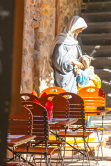 the yard coffee terrace tables with a saint Maria statue behind,  Riquewihr, Alsace, France, winery