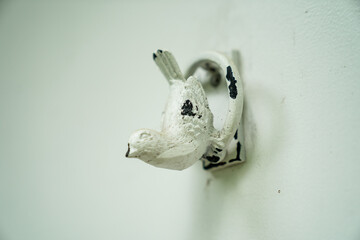 vintage white metal bird wall hook mounted on light background rustic home decor antique wall...