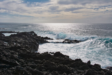 Waves breaking on the rocks in a beautiful sunset
