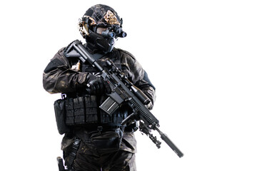 Special forces operative in tactical gear holding a rifle on isolated background ready for mission