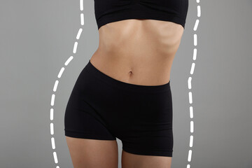 Slim woman showing her perfect body on grey background, closeup. Outline of previous overweight...
