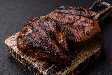 Grilled beef steak meat with salt and pepper. Beef steak grilled on a barbecue