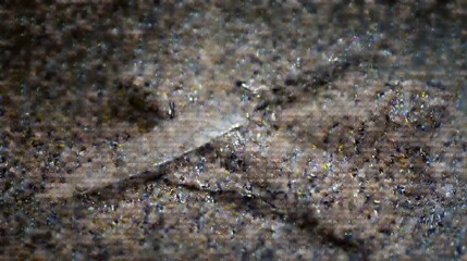Detailed view of a sharp knife and napkin on a textured dark tabletop