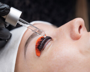 The process of professional lamination and tinting of eyelashes in the salon.