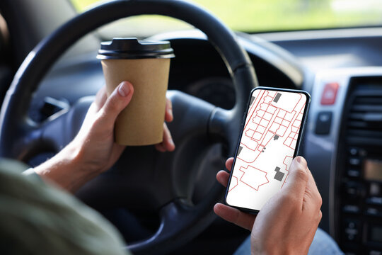 Man looking at city map on his mobile phone in car, closeup. Navigation app on device