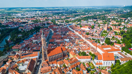 Landshut, a vibrant Bavarian town, viewed from the air. Features the medieval Trausnitz Castle on a hill and the striking Church of St. Martin with the tallest brick tower in the world