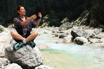 girl outdoors using tablet talking online with family, smiling, online conference, meeting