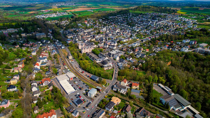A panoramic aerial view around the old town in the city Hadamar, Germany on a cloudy spring day